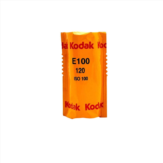 Kodak Ektachrome E100 color transparency film in orange packaging, ISO 100, for exceptional image quality.