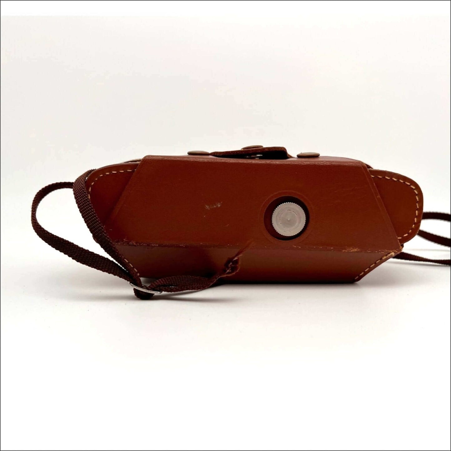 Vintage brown leather camera case with strap on white background