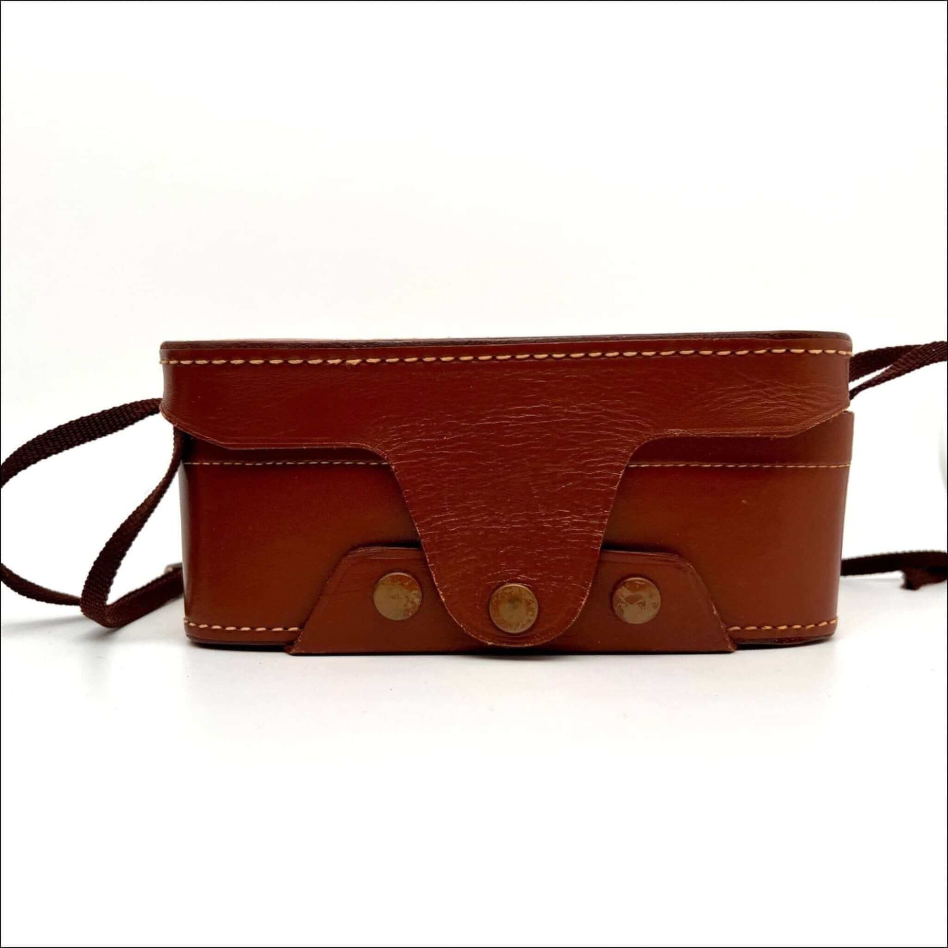 Brown leather camera case with buckle and shoulder strap