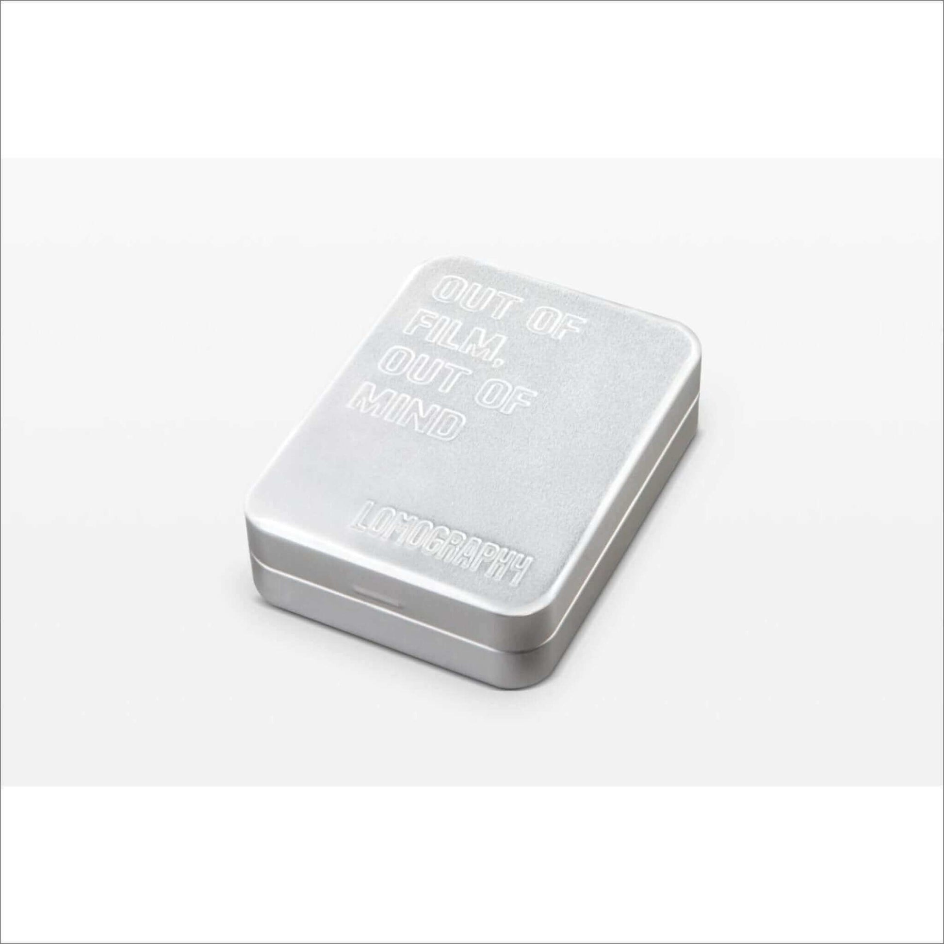 Silver box with engraved text "Out of film, out of mind" from Lomography.