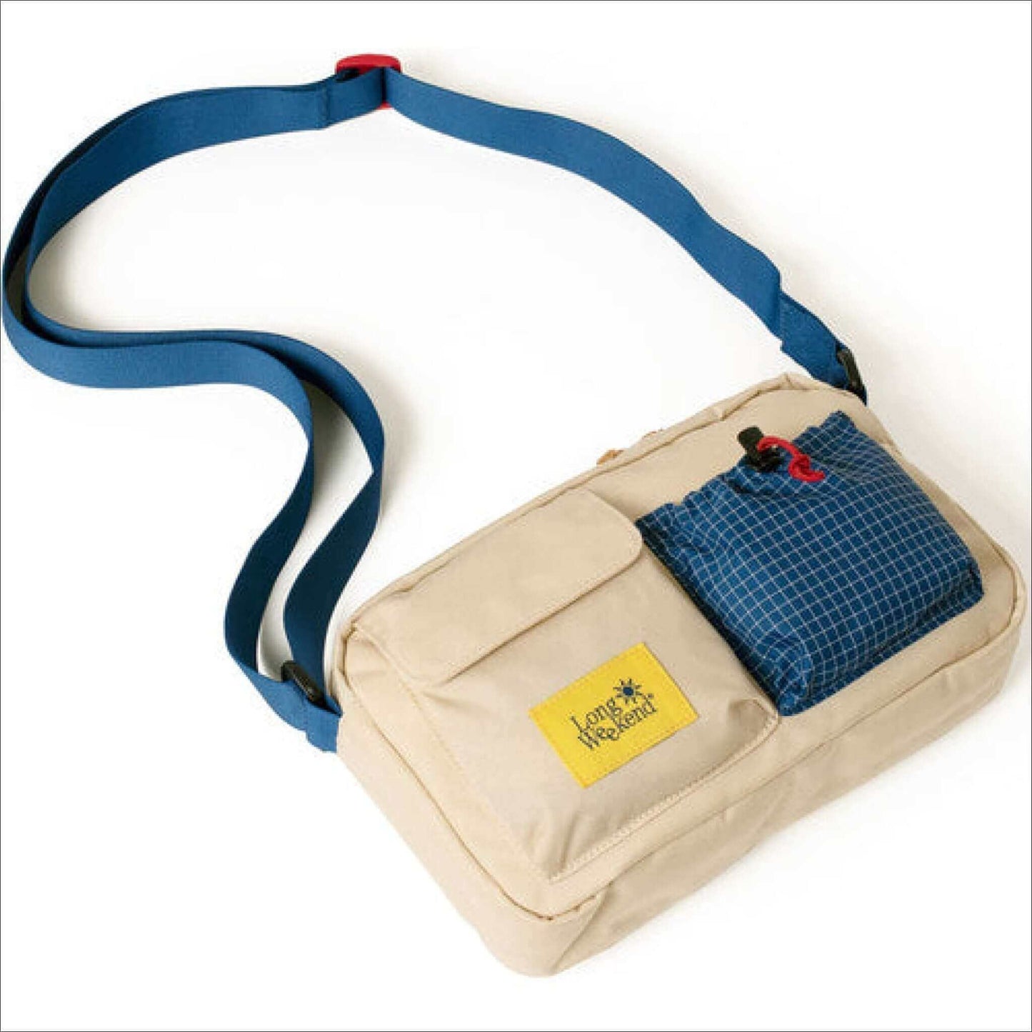 Beige shoulder bag with blue strap and front pocket, featuring a yellow logo and checkered blue pocket.