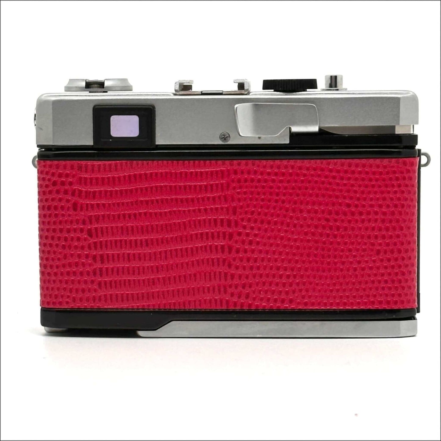 Retro camera with red textured back panel on a white background