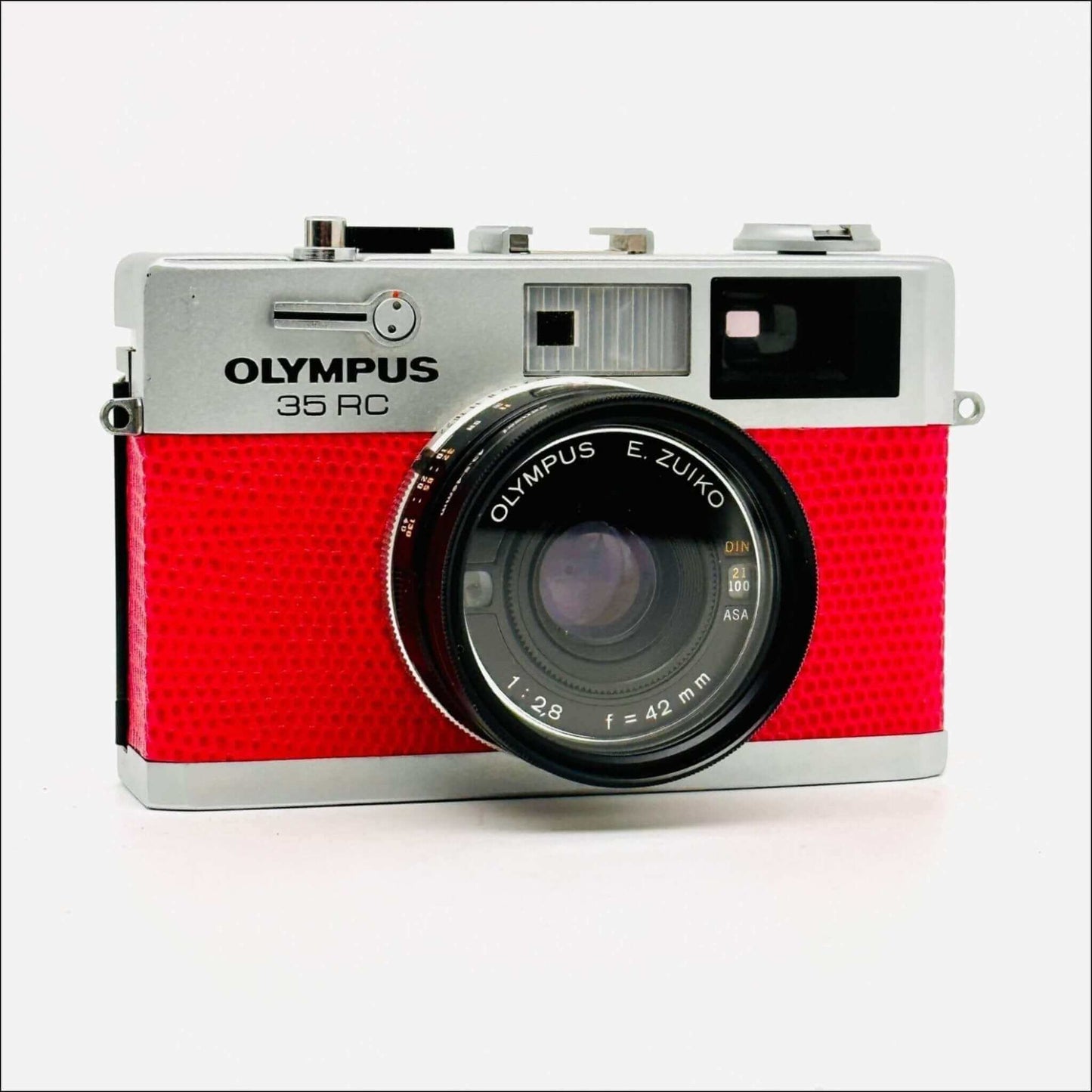 Vintage Olympus 35 RC camera with red body, showcasing E. Zuiko 42mm lens and classic design.