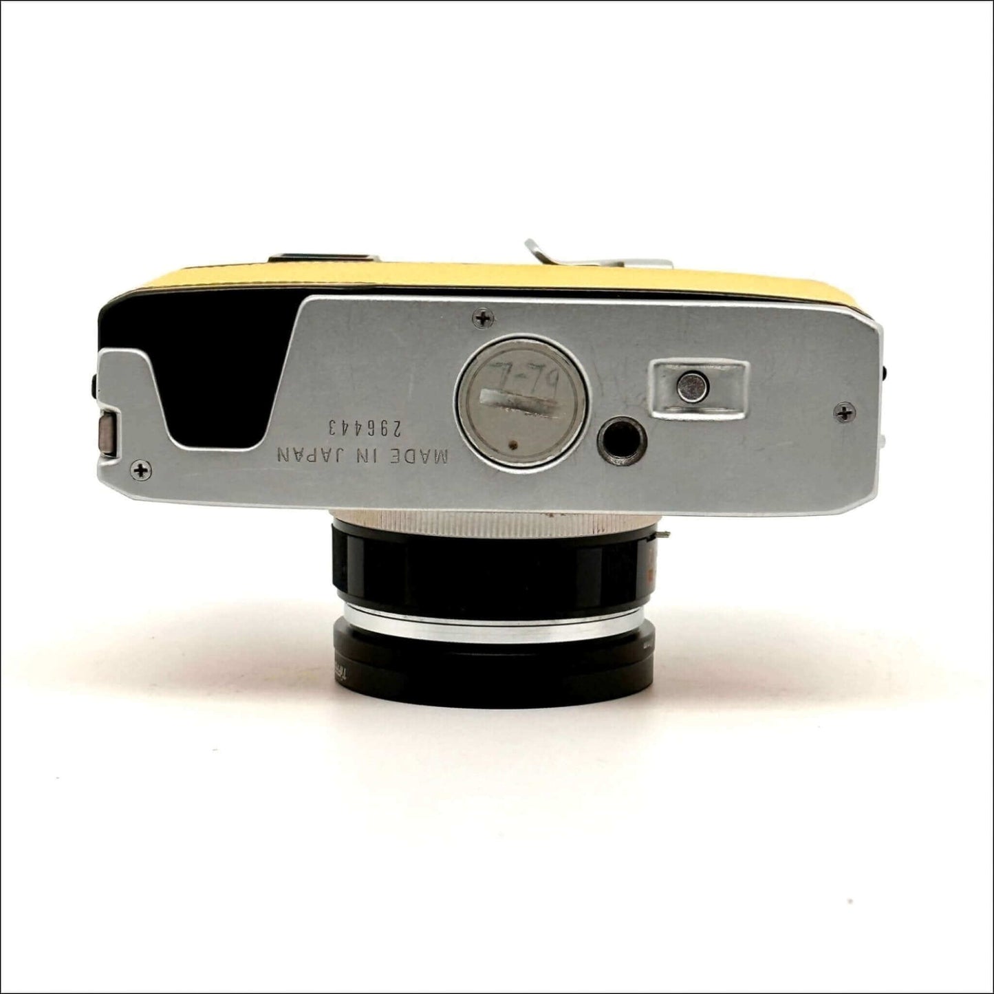 Bottom view of a vintage yellow and silver camera, showcasing details like the lens mount and serial number engraved on the body.