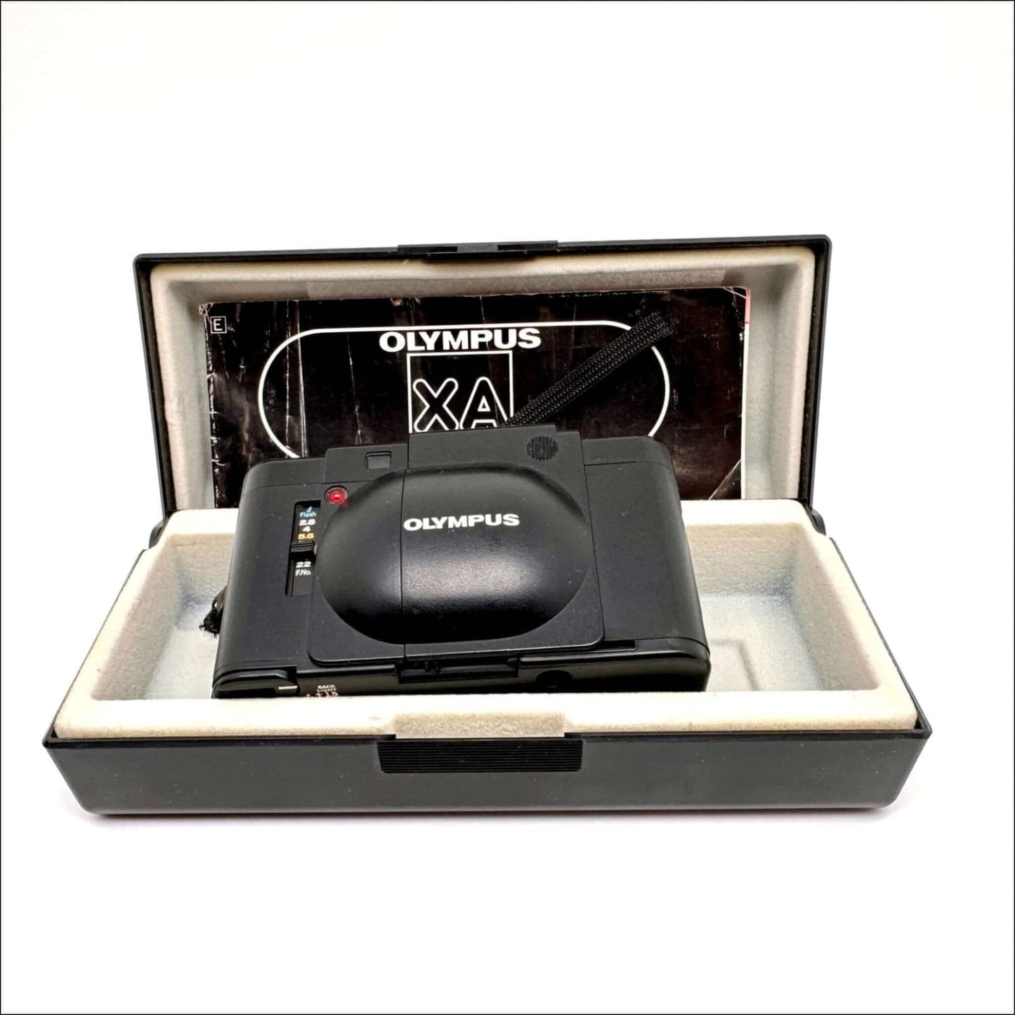 Vintage Olympus XA camera in original black case with user manual