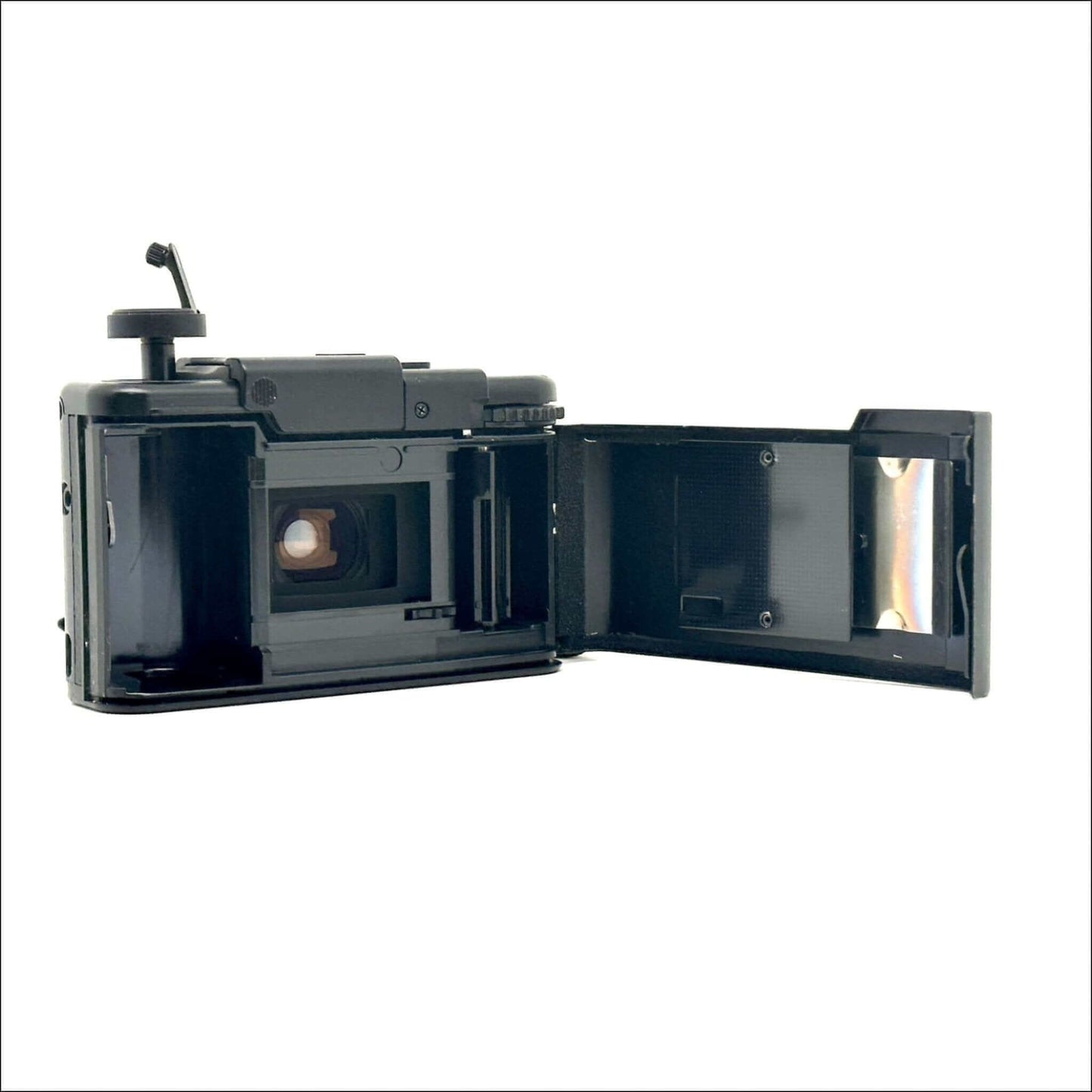 Open vintage film camera showing interior and film compartment