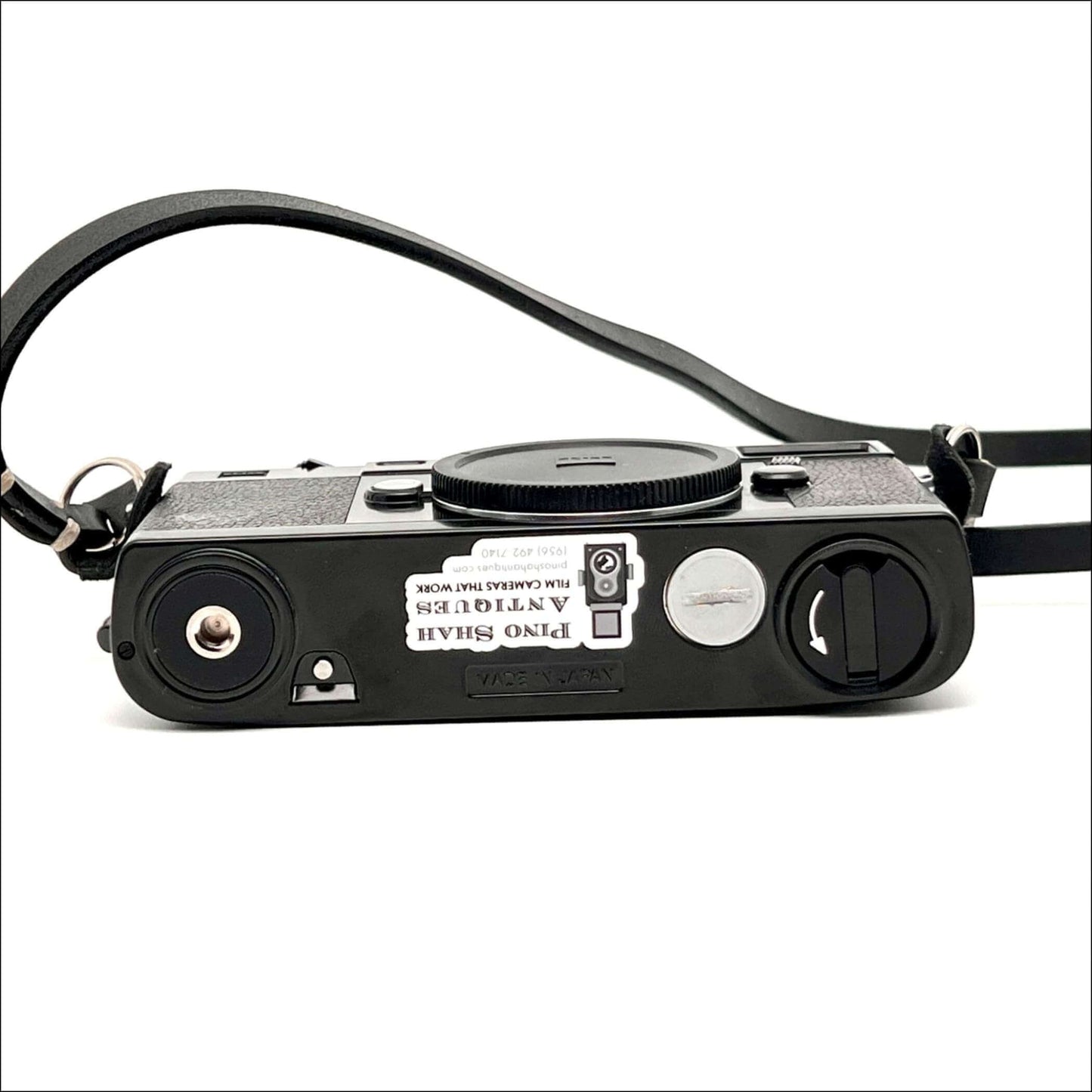 Zeiss Ikon ZM vintage 35mm film camera body in black, showcasing its back view and strap.